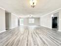 Large open-plan living area featuring gray vinyl floors and fresh paint; perfect for entertaining at 326 Old Farm Road, Woodstock, GA 30188