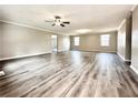 Spacious living room featuring modern gray vinyl floors, neutral walls, and ample natural light at 326 Old Farm Road, Woodstock, GA 30188