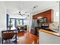 Modern kitchen open to dining area featuring stainless steel appliances, granite counters, and hardwood floors at 898 Oak Sw St # 3207, Atlanta, GA 30310