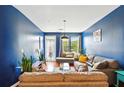 Bright living room with hardwood floors, a comfortable grey sofa, and large windows at 898 Oak Sw St # 3207, Atlanta, GA 30310