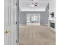 Spacious living room featuring neutral carpet, fireplace, and a ceiling fan at 1220 Skipping Rock Sw Ln, Grayson, GA 30017