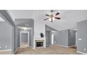 Bright living room includes a ceiling fan, fireplace, and multiple doorways at 1220 Skipping Rock Sw Ln, Grayson, GA 30017