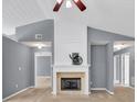 Cozy living room highlighted by a fireplace and open doorways at 1220 Skipping Rock Sw Ln, Grayson, GA 30017