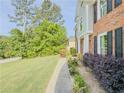 Brick and siding detail with meticulous landscaping featuring vibrant plants in a well-maintained yard at 2478 Roseberry Ln, Grayson, GA 30017