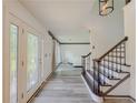 Bright foyer featuring luxury vinyl plank flooring and a staircase with rod iron spindles at 2478 Roseberry Ln, Grayson, GA 30017