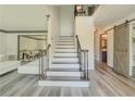 Grand foyer showcasing a staircase with rod iron spindles and luxury vinyl plank flooring at 2478 Roseberry Ln, Grayson, GA 30017