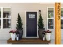 Close up of a stylish front door with decorative plants and modern house number at 2553 Creekwood Ter, Decatur, GA 30030
