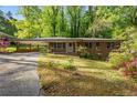 Traditional brick home with a porte-cochere, inviting front entrance, and a well-maintained lawn at 470 Hunnicutt Se Rd, Mableton, GA 30126