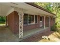 The red brick exterior home boasts detailed porch columns and a covered entryway, providing curb appeal at 470 Hunnicutt Se Rd, Mableton, GA 30126