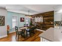 A dining area next to the kitchen featuring an accent wall and bamboo flooring at 1189 Norfolk Nw Dr, Acworth, GA 30102