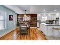 Open kitchen and dining area with light blue walls, stainless appliances, and hardwood floors at 1189 Norfolk Nw Dr, Acworth, GA 30102