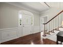 Elegant foyer featuring a staircase, hardwood floors, and beautiful molding detail around the entry door at 2870 Abbottswell Dr, Alpharetta, GA 30022