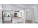 Modern kitchen featuring a butcher block island, stainless steel appliances, and white cabinets at 3132 Lunsford Cir, Covington, GA 30014