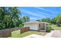 View of the home's side yard featuring green grass and a charming white exterior at 3132 Lunsford Cir, Covington, GA 30014