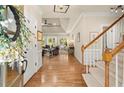 Bright foyer leading into a spacious living area with hardwood floors and a view of the backyard at 6250 Bannerhorn Run, Alpharetta, GA 30005