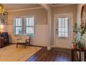Bright foyer with hardwood floors, wainscoting, and a front door with decorative glass at 660 Stately Dr, Woodstock, GA 30188