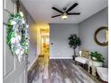 Inviting living area with stylish gray walls, hardwood flooring, and modern ceiling fan at 7750 Carnegie Dr, Fairburn, GA 30213