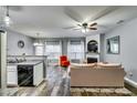 Cozy open-concept living room with granite countertops, stainless appliances, and fireplace feature at 7750 Carnegie Dr, Fairburn, GA 30213