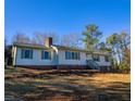 Traditional home featuring brick accents, complemented by green shutters and a well-maintained lawn at 11511 Highway 92, Woodstock, GA 30188