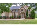 Two-story brick home with a well-maintained lawn and mature trees in a desirable neighborhood at 60 Heritage Keep, Covington, GA 30016