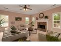 Cozy living room with a fireplace, neutral colors, and abundant natural light at 60 Heritage Keep, Covington, GA 30016