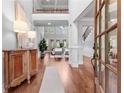 Grand foyer with hardwood floors, high ceilings, and an elegant staircase offering a view into the spacious living area at 1985 Chapel Estates Ln, Dacula, GA 30019