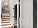 Entryway featuring staircase with hardwood steps and black interior door at 2329 Mason Dr # D24, Atlanta, GA 30316