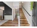 Bright entryway with wood floors, staircase with black railing and barn door at 429 Tannenhill Pl, Sugar Hill, GA 30518