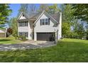 Spacious home with a well-maintained lawn and dark gray two-car garage at 429 Tannenhill Pl, Sugar Hill, GA 30518