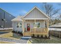 Charming home with a welcoming porch and landscaped front yard offers great curb appeal at 102 Dahlia Sw Ave, Atlanta, GA 30314