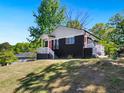 A cozy home features a manicured lawn, and a stylish black and grey exterior at 1599 Ezra Church Nw Dr, Atlanta, GA 30314