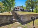 Charming home sits atop a rise, has an inviting front porch with an orange door at 1599 Ezra Church Nw Dr, Atlanta, GA 30314