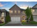 Charming two-story brick home featuring a two-car garage and a beautifully landscaped front yard at 1908 Weston Ln, Tucker, GA 30084