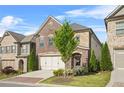 Charming two-story brick home featuring a two-car garage and a beautifully landscaped front yard at 1908 Weston Ln, Tucker, GA 30084