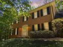 Classic brick home with black shutters, an arched entryway, and lovely landscaping creating a welcoming facade at 3573 Turtle Cove Se Ct, Marietta, GA 30067