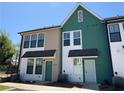 New townhome exterior with unique two-tone color scheme, black framed windows, and covered entryway at 1095 Tucker Ave # 207, Atlanta, GA 30310