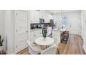 Bright, modern kitchen with a breakfast area and an island with stool seating; all in a relaxing color scheme at 1095 Tucker Ave # 207, Atlanta, GA 30310