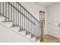 Elegant staircase with wooden treads and black metal railings leading to the upper level at 1095 Tucker Ave # 207, Atlanta, GA 30310