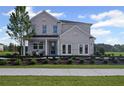 Beautiful two-story home with white brick, a black fence, and a well-manicured lawn at 126 Kenney Way, Locust Grove, GA 30248
