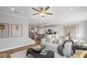Open-concept living area with modern decor, seamlessly connecting to the kitchen and dining area at 126 Kenney Way, Locust Grove, GA 30248