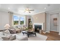 Cozy living room with a fireplace, plush seating, natural light, and a serene color palette at 126 Kenney Way, Locust Grove, GA 30248