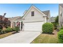 View of an attractive two-story home with a two-car garage and mature landscaping at 1620 Diplomat Dr, Cumming, GA 30041