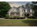 Charming two-story home with well-maintained landscaping, stone accents, and a lush green lawn at 2305 Lochinver Sw Ln, Conyers, GA 30094