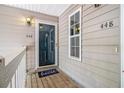 Inviting front porch with space to relax featuring numbers 446 and 448 and a doormat at 446 Teal Ct, Roswell, GA 30076