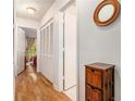 Bright hallway with wood floors, closet, and a view leading into a bedroom at 446 Teal Ct, Roswell, GA 30076