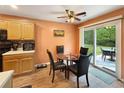 Dining area features a glass table, seating for four, wood floors and sliding glass doors leading to a patio at 698 Beranda Cir, Douglasville, GA 30134