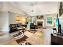 Spacious living room featuring a stone fireplace, vaulted ceilings, and an abundance of natural light at 698 Beranda Cir, Douglasville, GA 30134