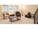Cozy living room featuring comfortable seating, a glass-top coffee table, and ample natural light from large windows at 7098 Stonington Dr, Atlanta, GA 30328