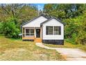 Charming home with a cozy porch, new siding, dark window shutters, and a well-manicured lawn at 1111 Osborne Sw St, Atlanta, GA 30310