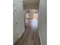 Inviting entryway showcasing modern wood floors, neutral paint, and arched doorways leading to various living spaces at 290 Azalea Cir, Cumming, GA 30040